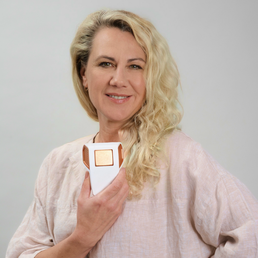 Mulher sorridente a segurar o dispositivo Héra contra o peito